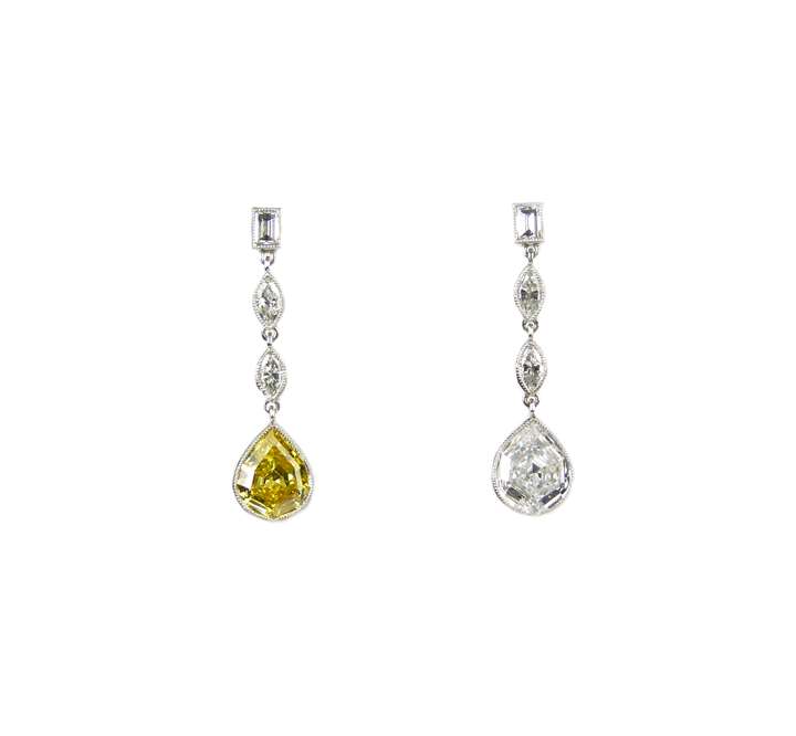 Pair of fancy pear shaped canary yellow and white diamond pendant earrings